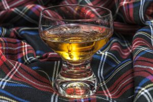 Glass,of,scotch,whiskey,on,scottish,cell,background