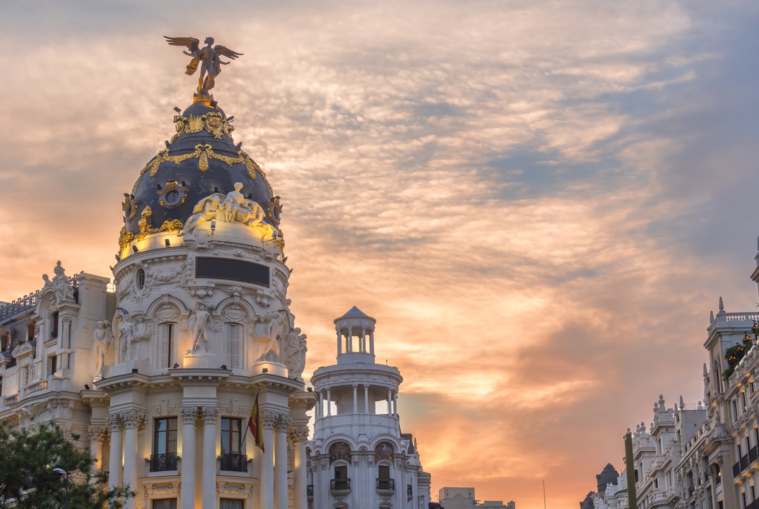 Madrid downtown in gran via main shopping street with traffic light during twilight sunset,Spain.